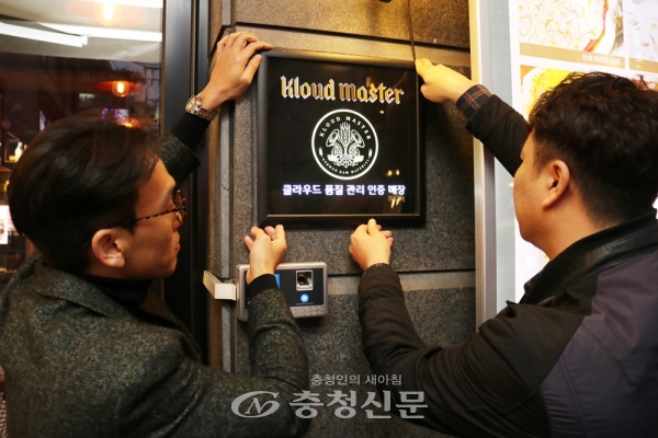 사진은 지난 8일 '클라우드 마스터' 500호 매장으로 인증받은 서울 강남 '쿼터백'에서 직원들이 마스터 인증 엠블럼을 설치하고 있는 모습. (사진=롯데주류 제공)