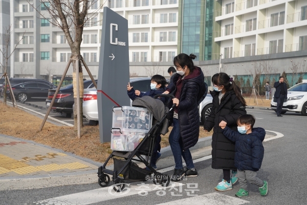임시생활시설에서 나온 가족이 마스크를 쓰고 환송 버스로 이동하고 있다. (사진=진천군 제공)