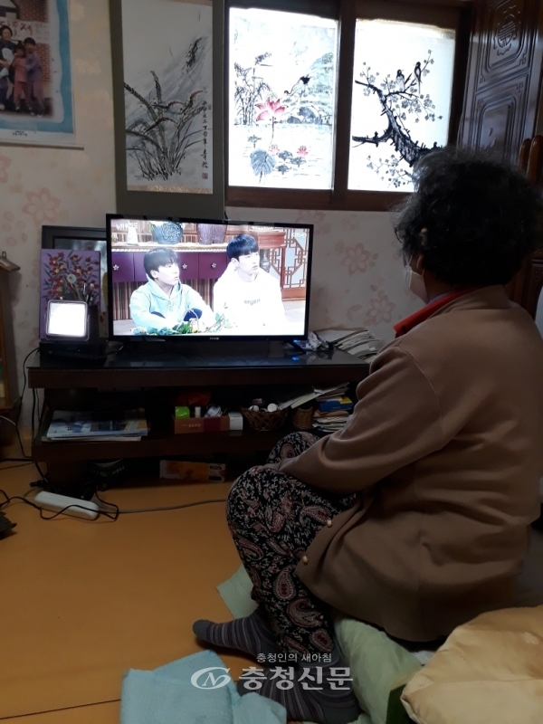 홍동면 주민이 지원받은 TV를 시청하고 있는 모습 (사진=홍성군 제공)